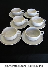 Mid Century Modern Gray Coffee Cups And Saucers On A Black Limbo Background With A Retro Vintage Look, Vertical Format