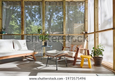 A mid century modern screened in porch