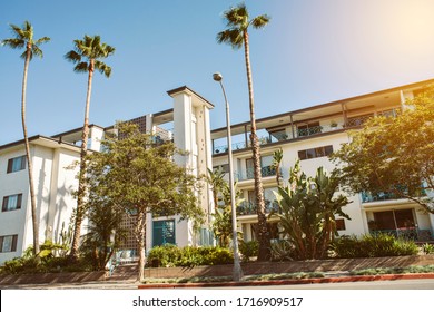 Mid Century Multi Family Apartment Building with Palm Trees - Real Estate - Investment Syndication - Sunny - Shutterstock ID 1716909517