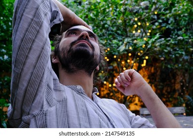 Mid Man Looking Up Thoughtful In His Garden