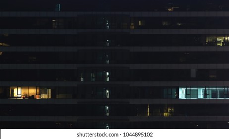 Mid Night Shift. Eyes Of A Building. Someone Is Not Going Home In Time Tonight. Office Tower In The Night With Two Rooms Still Turning Light On.  