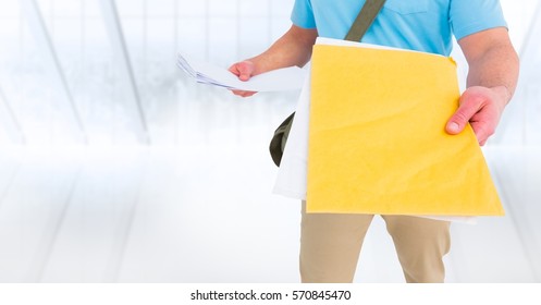 Mid Section Of Delivery Man With Document Against White Background