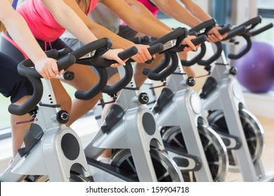 Mid section of four people working out at a class in gym - Powered by Shutterstock