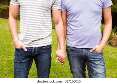 Mid Section Of Gay Couple With Hand In Hand In Park