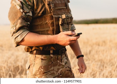 Mid section of military soldier using mobile phone in boot camp. letter from war. - Powered by Shutterstock