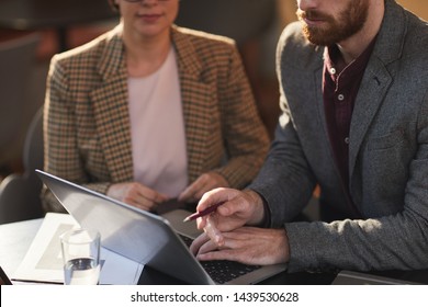 Mid Section Portrait Of Two Business People Pointing At Laptop Screen During Meeting In Cafe, Copy Space