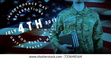 Mid section of soldier holding books against multi colored happy 4th of july text against white background