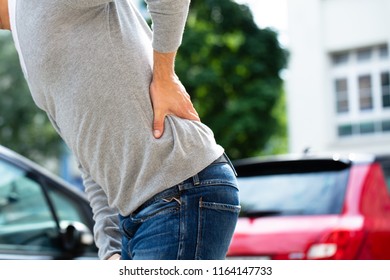 Mid Section View Of A Man Suffering From Back Pain