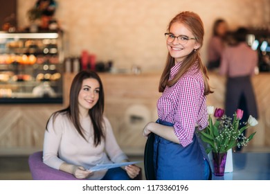 Mid Section Of Waitress Taking Order At Restaurant