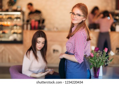 Mid Section Of Waitress Taking Order At Restaurant