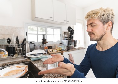 Mid-adult Man Complaining About Dirty Dishes In His Messy Kitchen. Close Up To His Face