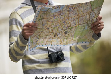 A mid-adult man  looking at a map