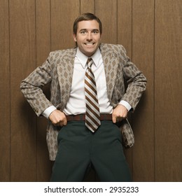 Mid-adult Smiling  Caucasian Male In Retro Suit Pulling Up On Pants.