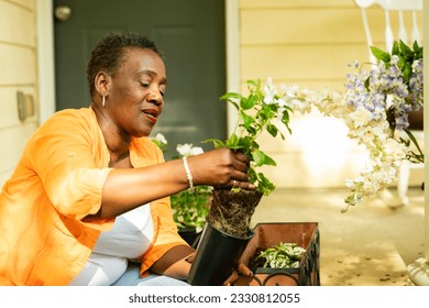 Mid-adult woman with plants on front porch - Powered by Shutterstock