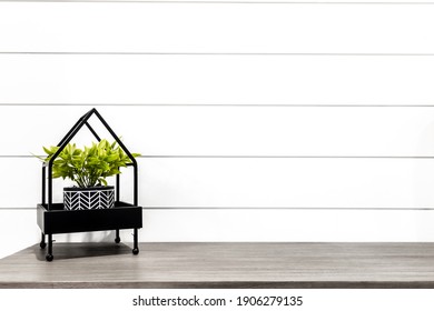 Midcentury Modern Decor On A Grey Desk In Front Of White Shiplap 