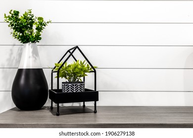 Midcentury Modern Decor On A Grey Desk In Front Of White Shiplap 