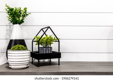 Midcentury Modern Decor On A Grey Desk In Front Of White Shiplap 