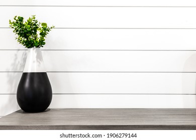 Midcentury Modern Decor On A Grey Desk In Front Of White Shiplap 