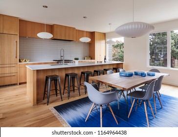 Mid-century modern kitchen with custom wood cabinets and blue accents. Portland, Oregon