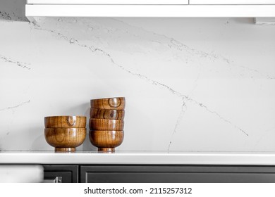 Midcentury Modern Kitchen And Dining Room Interior Design With Black Cabinets, White Cabinets, White Quartz And Walnut Accents