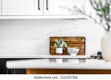 Midcentury Modern Kitchen And Dining Room Interior Design With Black Cabinets, White Cabinets, White Quartz And Walnut Accents