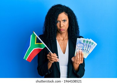 Middle Age African American Woman Holding South African Flag And Rands Depressed And Worry For Distress, Crying Angry And Afraid. Sad Expression. 