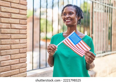 Middle Age African American Woman Smiling Confident Holding United States Flag At Street