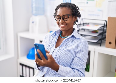 Middle age african american woman business worker using smartphone working at office - Powered by Shutterstock