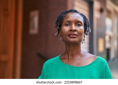 Middle age african american woman standing with serious expression at street - Powered by Shutterstock