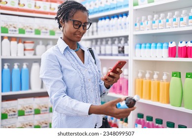 Middle age african american woman customer make photo by smartphone to medicine bottle at pharmacy - Powered by Shutterstock