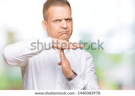 Middle age arab elegant man over isolated background Doing time out gesture with hands, frustrated and serious face