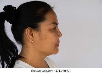 Middle age Asian women focus on cheek line over white background