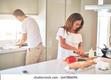 Middle Age Beautiful Couple Cooking Together On The Kitchen