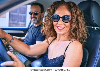 Middle Age Beautiful Couple On Vacation Wearing Sunglasses Smiling Happy Driving Car.