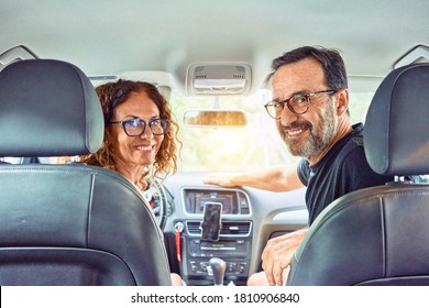 Middle Age Beautiful Couple On Vacation Wearing Glasses Smiling Happy Driving Car.