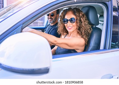 Middle Age Beautiful Couple On Vacation Wearing Sunglasses Smiling Happy Driving Car.