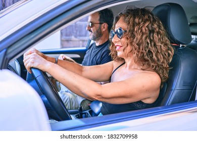 Middle Age Beautiful Couple On Vacation Wearing Sunglasses Smiling Happy Driving Car.