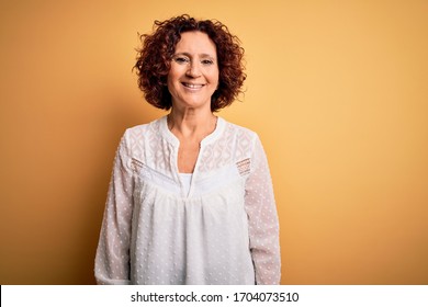 Middle Age Beautiful Curly Hair Woman Wearing Casual Summer Dress Over Yellow Background With A Happy And Cool Smile On Face. Lucky Person.