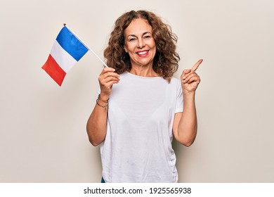 Middle Age Beautiful Patriotic Woman Holding French Flag Over Isolated White Background Smiling Happy Pointing With Hand And Finger To The Side