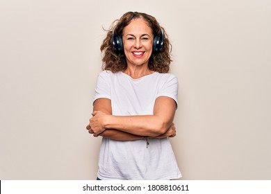 Middle Age Beautiful Woman Listening To Music Using Headphones Over White Background Happy Face Smiling With Crossed Arms Looking At The Camera. Positive Person.