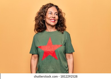 Middle Age Beautiful Woman Wearing T-shirt With Red Star Revolutionary Symbol Of Communism Looking To Side, Relax Profile Pose With Natural Face And Confident Smile.