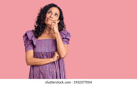 Middle Age Beautiful Woman Wearing Casual Dress Serious Face Thinking About Question With Hand On Chin, Thoughtful About Confusing Idea 