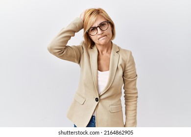 Middle Age Blonde Business Woman Standing Over Isolated Background Confuse And Wondering About Question. Uncertain With Doubt, Thinking With Hand On Head. Pensive Concept. 