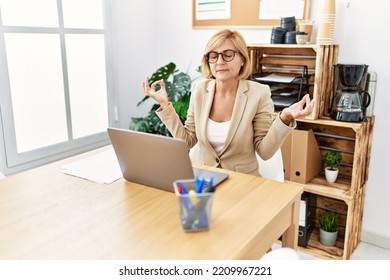 Middle Age Blonde Woman Smiling Confident Doing Yoga Exercise At Office