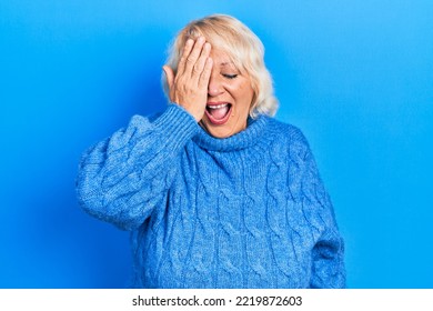 Middle Age Blonde Woman Wearing Casual Clothes Yawning Tired Covering Half Face, Eye And Mouth With Hand. Face Hurts In Pain. 