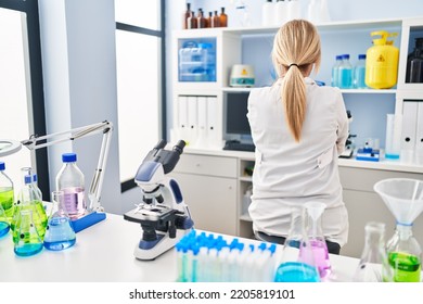 Middle Age Blonde Woman Working At Scientist Laboratory Standing Backwards Looking Away With Crossed Arms 