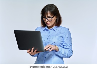 Middle Age Business Woman Using Laptop, On Light Background