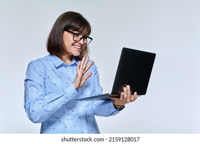 Middle Age Business Woman Using Laptop For Conference Video Call, On Light Studio Background