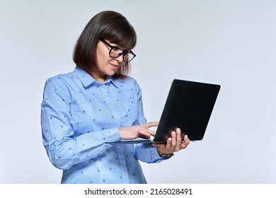 Middle Age Business Woman Using Laptop, On Light Background