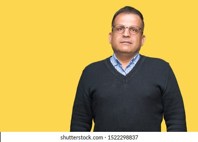 Middle Age Bussines Arab Man Wearing Glasses Over Isolated Background With Serious Expression On Face. Simple And Natural Looking At The Camera.